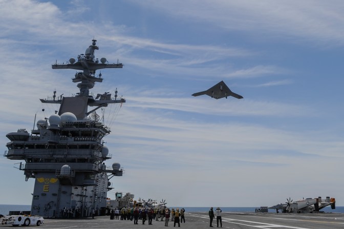 An X-47B Unmanned Combat Air System (UCAS) demonstrator flies over the aircraft carrier USS George H.W. Bush (CVN 77) May 14. George H.W. Bush is the first aircraft carrier to successfully catapult launch an unmanned aircraft from its flight deck. (U.S. Navy photo courtesy of Northrop Grumman by Alan Radecki/Released)