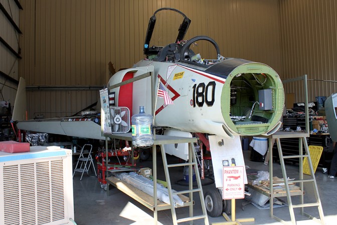 145310 sit in the maintenance hangar minus the nose cone. The cone has been removed to allow the aircraft to fit inside with the door closed.