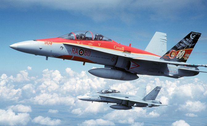 Two Canadian Forces 410 Squadron CF-188B Hornet fighter flying over the Utah Test and Training Range (USA) for planned engagements during the "Tiger Meet of the Americas" on 9 August 2001. The first aircraft is painted in a special scheme commemorating the 60th anniversary of 410 Squadron. USAF Photograph by SSgt Greg L. Davis.