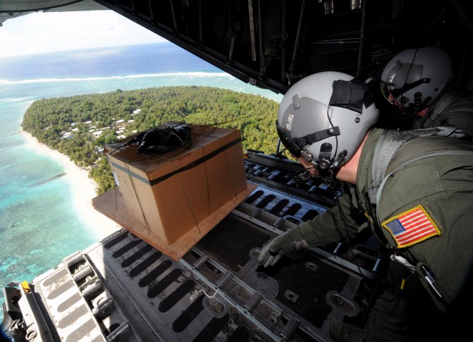 Operation Christmas Drop 2008: Tech. Sgt. Heath Bahyi and Chief Master Sgt. Michael Sundberg push out a boxed pallet of donated goods from a C-130 Hercules during Operation Christmas Drop Dec. 19 over the remote Island of Yap. Airmen today continue the tradition of delivering supplies to remote islands of the Commonwealth of the Northern Marianas Islands, Yap, Palau, Chuuk and Pohnpei. In all, more than 180 boxes were built for the humanitarian mission, making 2008 one of the largest drops in Operation Christmas Drop's 57-year history. Sergeant Bahyi and Chief Sundberg are loadmasters from the 36th Airlift Squadron from Yokota Air Base, Japan. (U.S. Air Force photograph/Released)