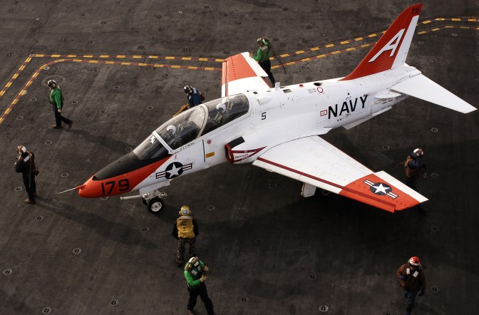 Flight deck personnel prepare a T-45A Goshawk for taxi across the flight deck aboard the Nimitz-class aircraft carrier USS Ronald Reagan (CVN 76). U.S. Navy photo by Mass Communication Specialist 2nd Class Aaron Burden (RELEASED)