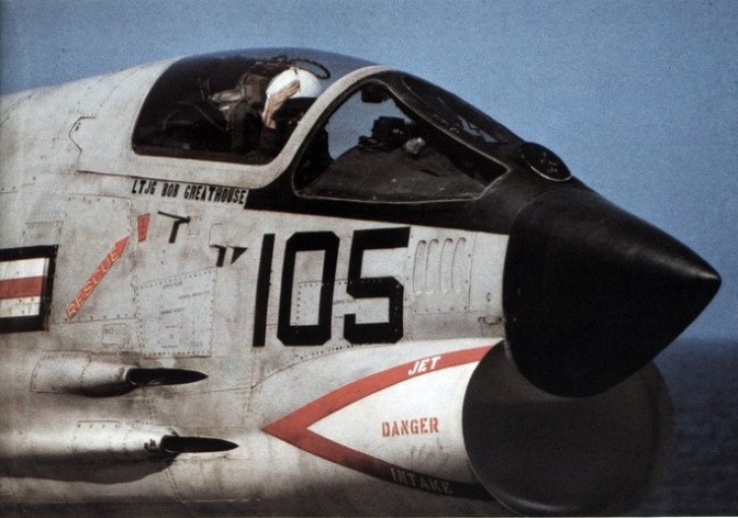 A U.S. Navy pilot of a Vought F-8H Crusader from Fighter Squadron VF-211 "Checkmates" salutes the catapult crew before launching from the aircraft carrier USS Hancock (CVA-19). VF-211 was assigned to Carrier Air Wing 21 (CVW-21) for a deployment to Vietnam from 18 July 1968 to 3 March 1969. (U.S. Navy archival photograph/released)