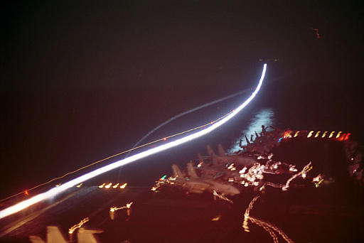 A nighttime long-exposure shot of fighter jets launching from the USS Enterprise on October 7th, 2001, on strike missions against Al Qaeda and Taliban strongholds. (Navy photo by Todd A. Bent via AP) 