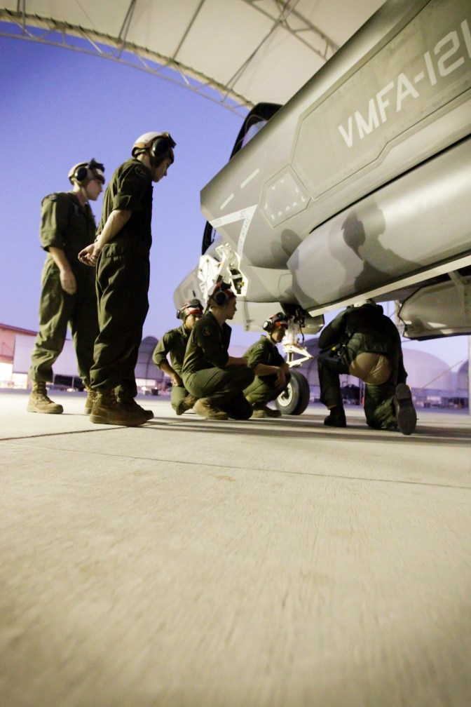 U.S. Marines with Marine Fighter Attack Squadron 121 (VMFA-121) inspect an F-35B Lightning II aircraft in support of Weapons and Tactics Instructor Course (WTI) 1-16 at Marine Corps Air Station Yuma, Ariz., Oct. 1, 2015. Newbold's flight was historic in nature since it marked the first WTI class to fully integrate F-35s into the course. WTI 1-16 is a seven week training event hosted by Marine Aviation Weapons and Tactics Squadron One (MAWTS-1) cadre which emphasizes operation integration of the six functions of Marine Corps aviation in support of a Marine Air Ground Task Force. MAWTS-1 provides standardized advanced tactical training and certification of unit instructor qualifications to support Marine Aviation Training and Readiness and assists in developing and employing aviation weapons and tactics. (U.S. Marine Corps photo by Chief Warrant Officer 3 Jorge A. Dimmer MAWTS-1 COMCAM/Released)