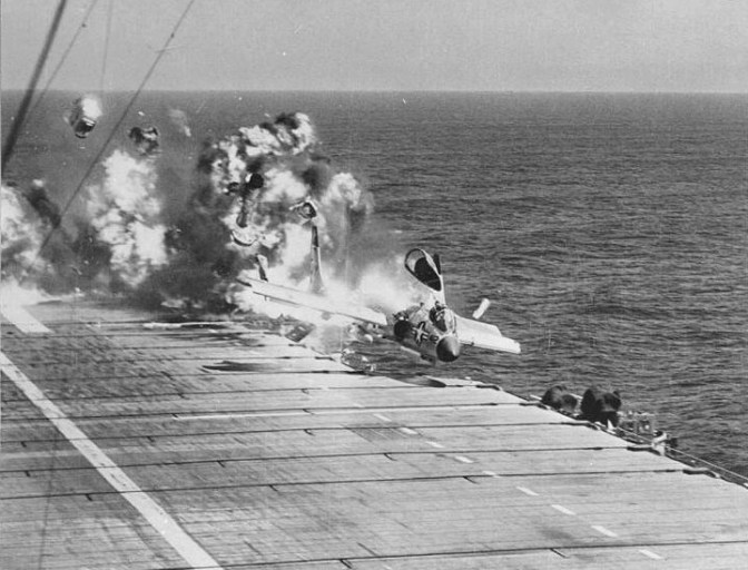 F7U-3 Cutlass, BuNo 129595, 'D 412', of VF-124, suffers ramp strike on landing aboard USS Hancock during carrier qualifications off of the California coast. The pilot, LCDR Jay Alkire, USNR, executive officer of VF-124, along with a number of deck crew. (US Navy/released)